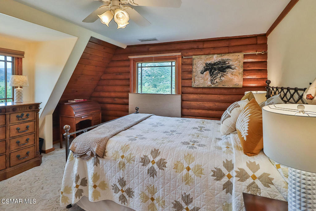 3030 Triunfo Canyon Road Agoura Hills, CA 91301 - Photo 29 of 50 a bedroom with a bed a dresser and next to a window