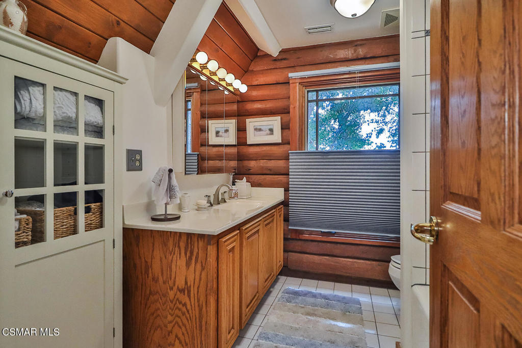 3030 Triunfo Canyon Road Agoura Hills, CA 91301 - Photo 32 of 50 a bathroom with a sink and a large mirror
