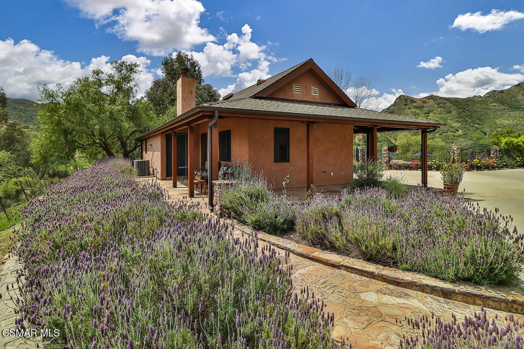 3030 Triunfo Canyon Road Agoura Hills, CA 91301 - Photo 37 of 50 a front view of a house with a yard