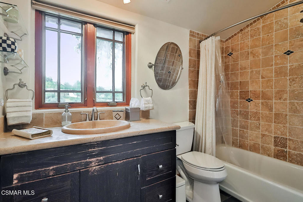 3030 Triunfo Canyon Road Agoura Hills, CA 91301 - Photo 40 of 50 a bathroom with a sink a toilet and a mirror