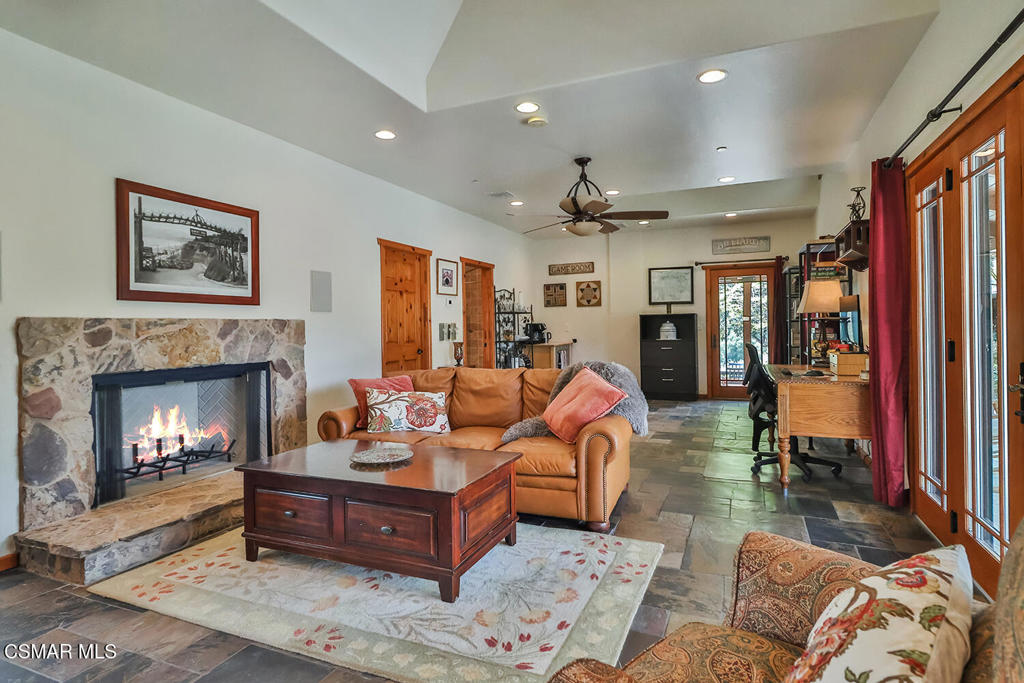 3030 Triunfo Canyon Road Agoura Hills, CA 91301 - Photo 42 of 50 a living room with furniture and a fireplace
