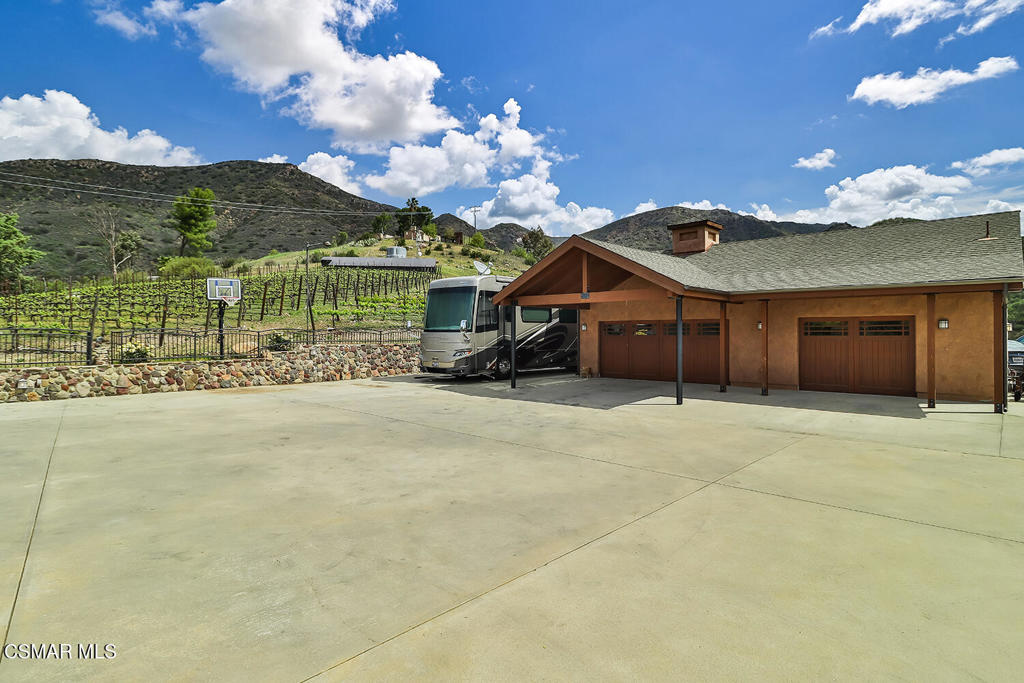 3030 Triunfo Canyon Road Agoura Hills, CA 91301 - Photo 8 of 50 a front view of a house with a yard and garage