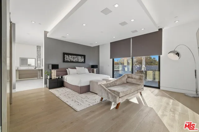 a reading room with furniture and a wooden floor