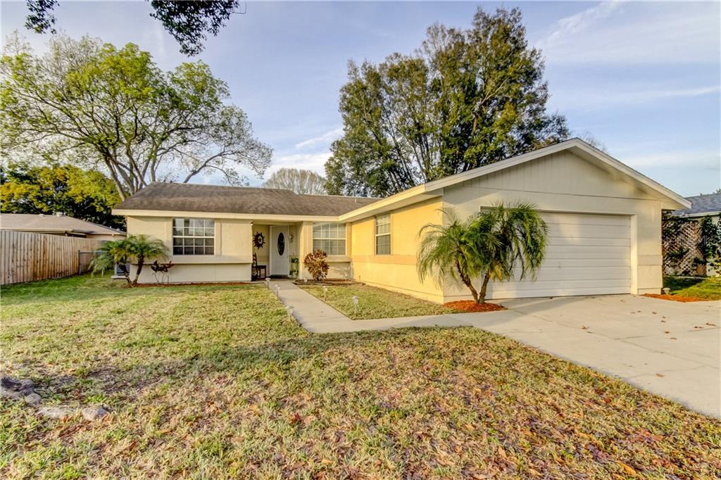 7829 Edinburgh Drive New Port Richey, FL 34653 - Photo 1 of 1 a front view of a house with a yard and a garage