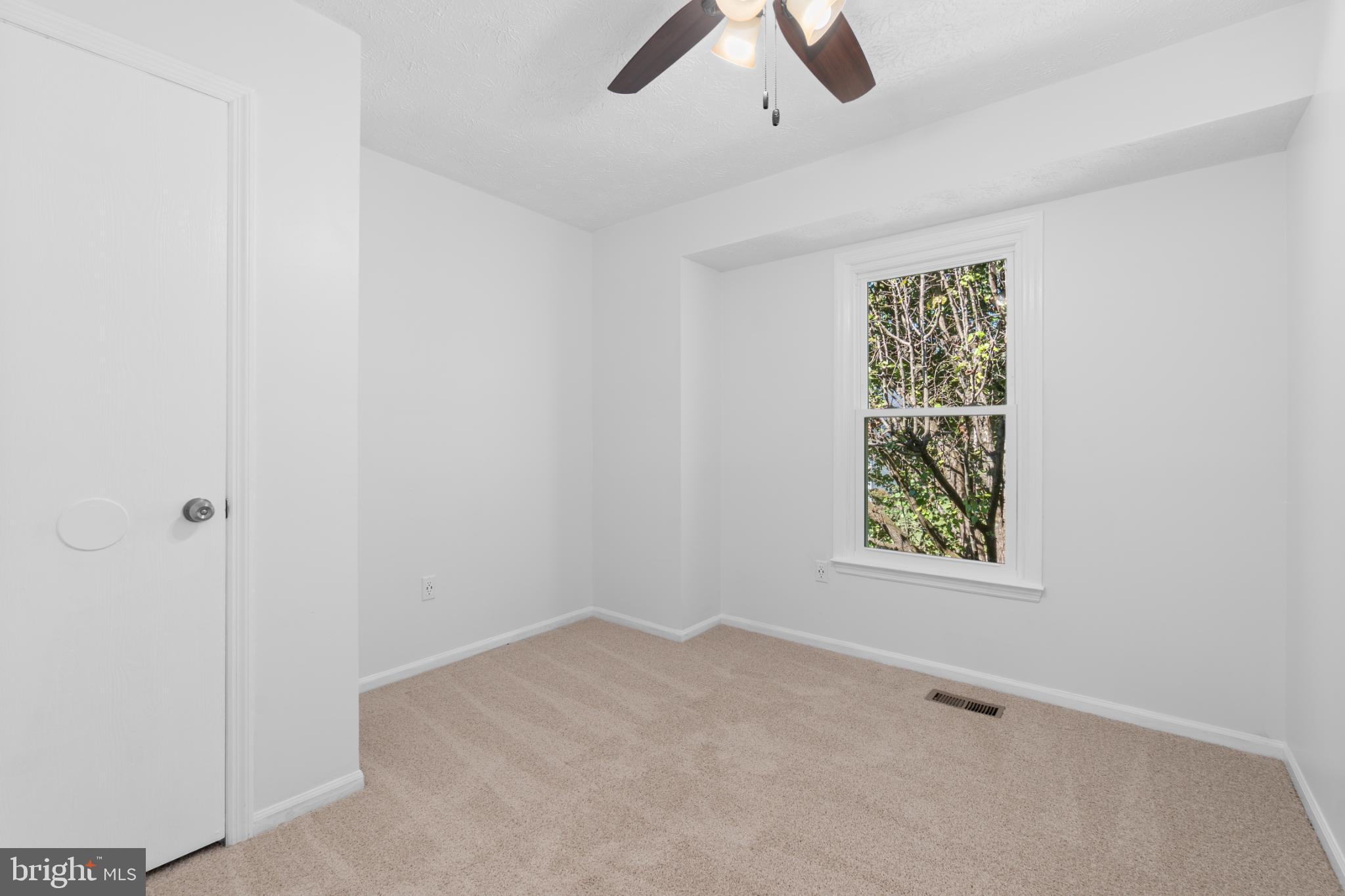 9079 Manorwood Road Laurel, MD 20723 - Photo 18 of 35 an empty room with ceiling fan and window
