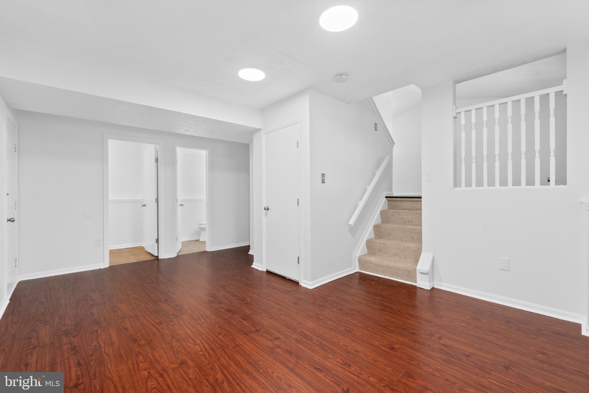 9079 Manorwood Road Laurel, MD 20723 - Photo 24 of 35 a view of an empty room with wooden floor and a window