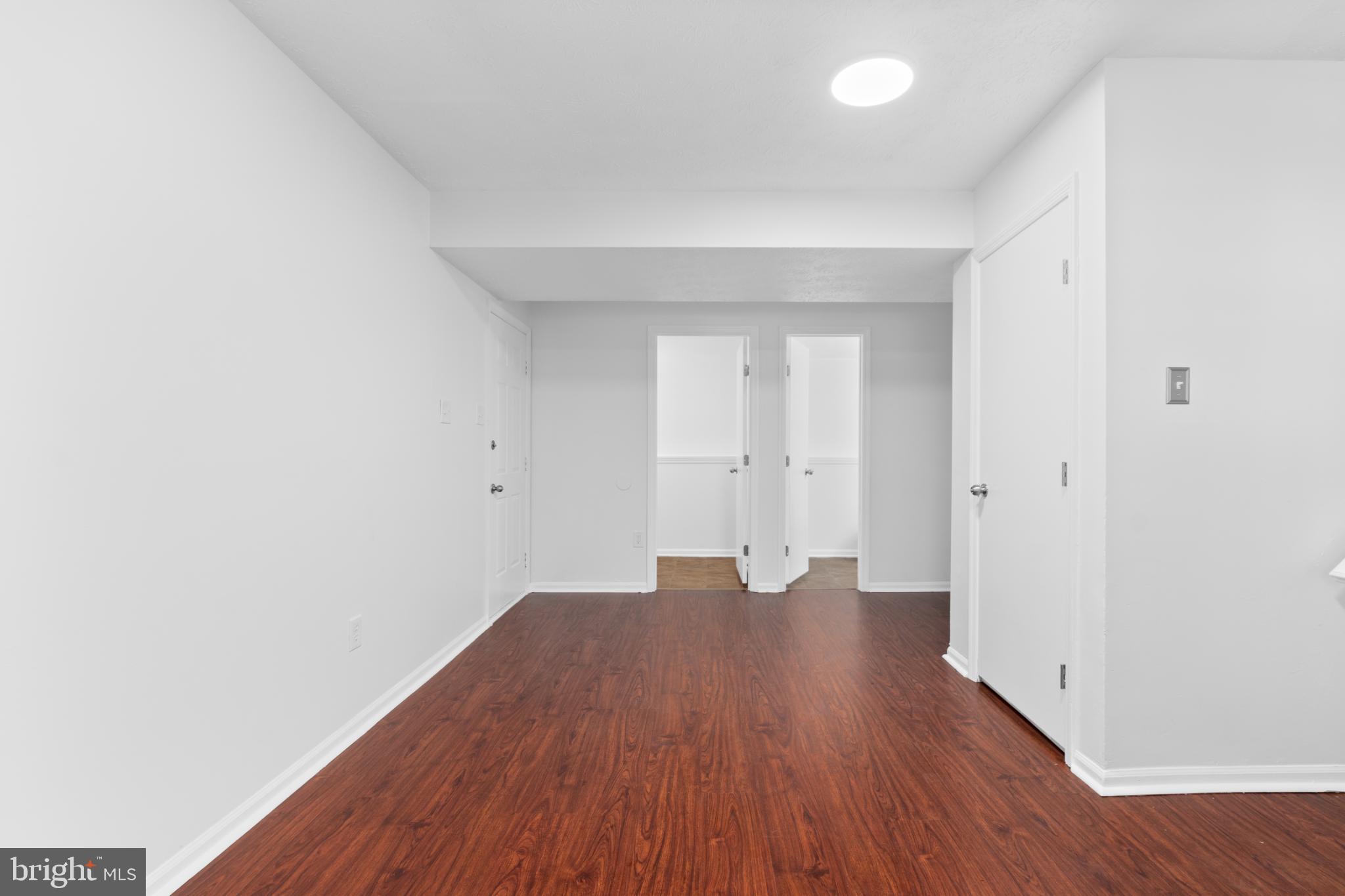 9079 Manorwood Road Laurel, MD 20723 - Photo 25 of 35 a view of an empty room with wooden floor
