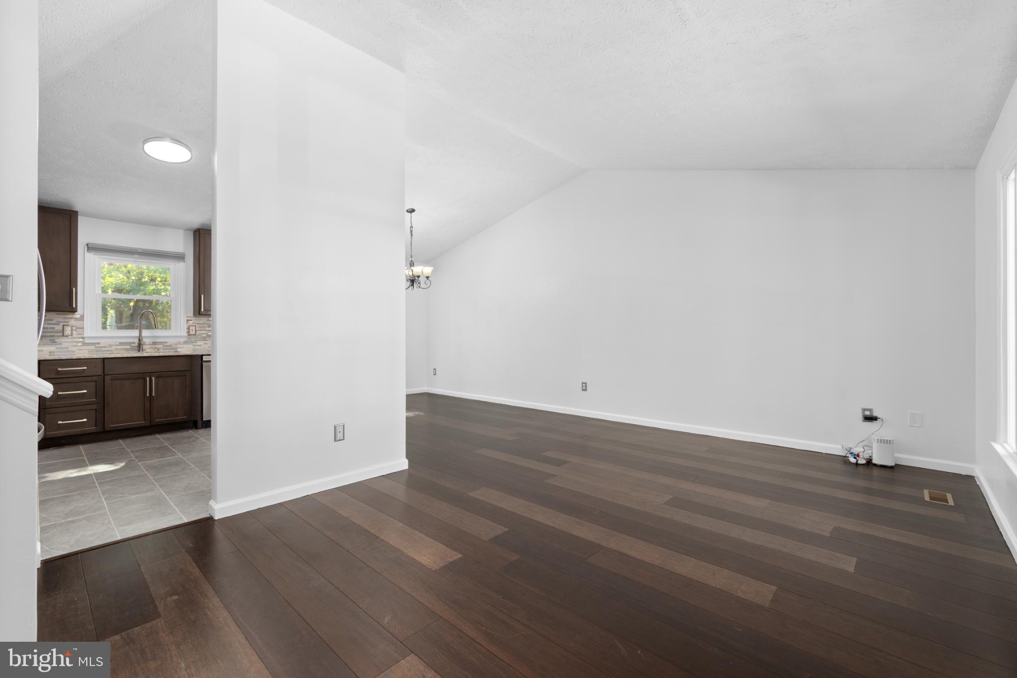 9079 Manorwood Road Laurel, MD 20723 - Photo 4 of 35 an empty room with wooden floor and windows