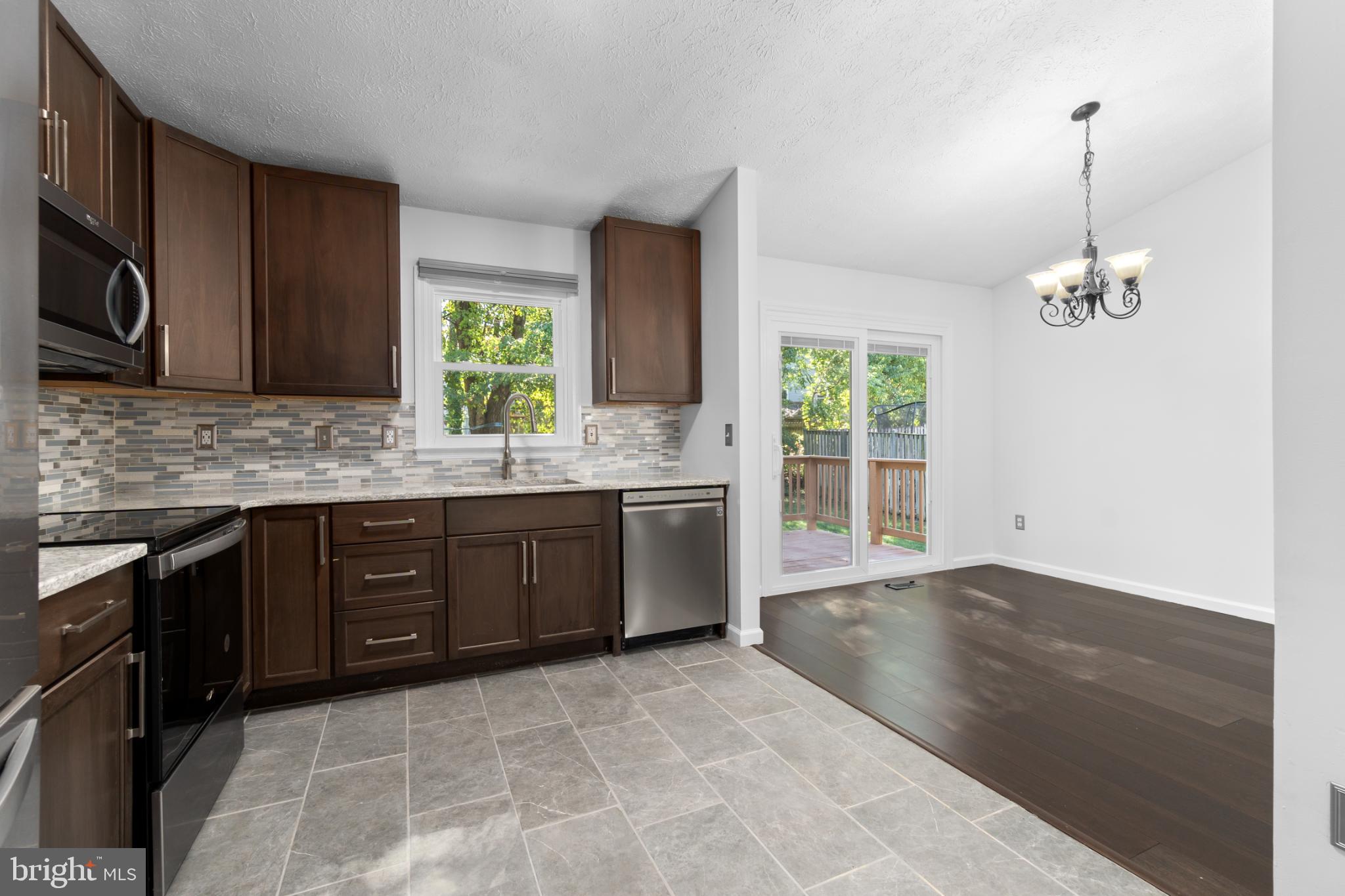 9079 Manorwood Road Laurel, MD 20723 - Photo 9 of 35 a kitchen with a sink cabinets and window