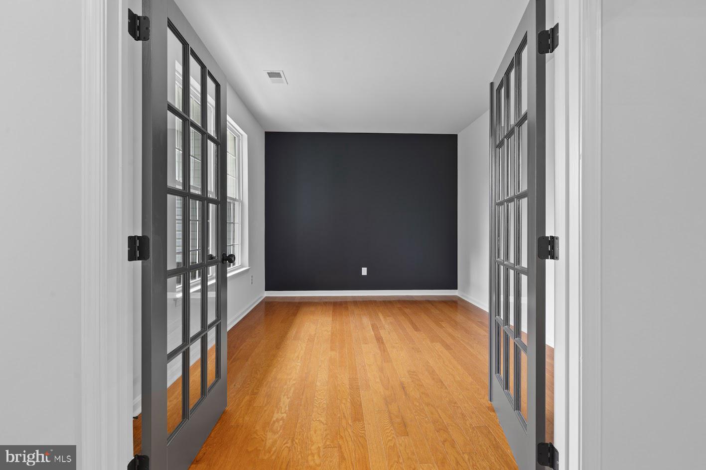 1111 Ruddy Duck Court Denton, MD 21629 - Photo 11 of 48 a view of an empty room with wooden floor and a bathroom