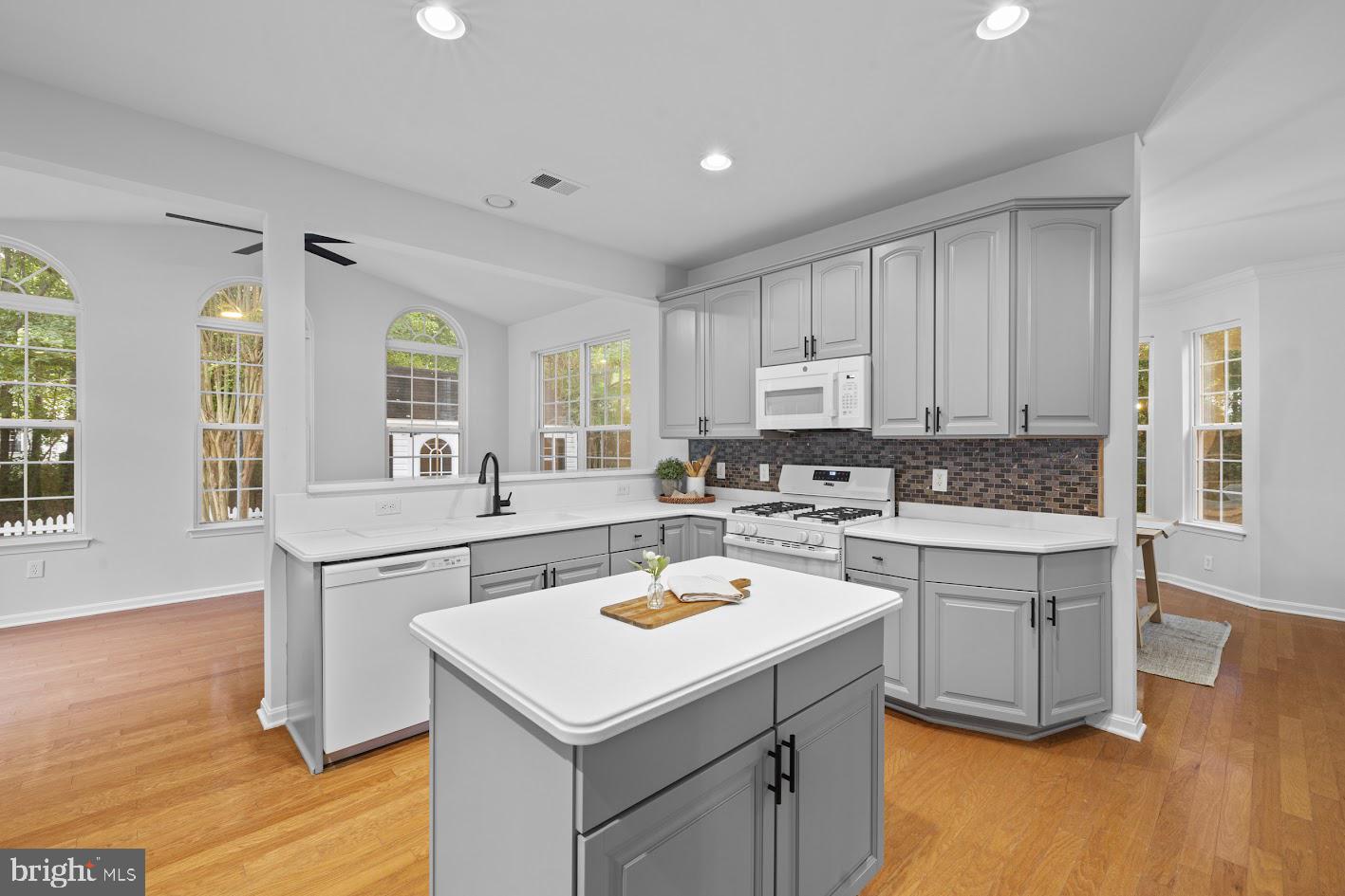 1111 Ruddy Duck Court Denton, MD 21629 - Photo 13 of 48 a kitchen with a sink stove and cabinets