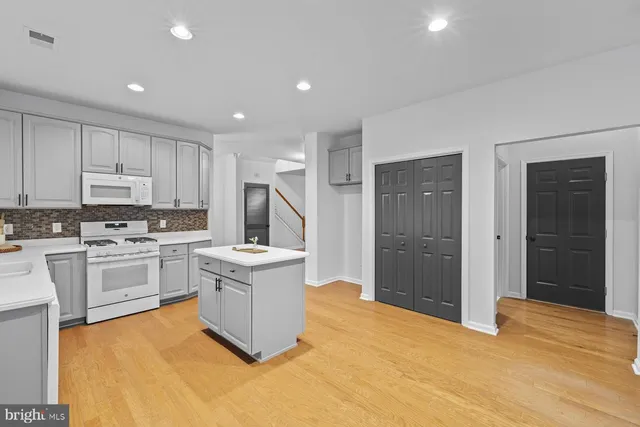 a kitchen with stainless steel appliances granite countertop a stove and a refrigerator