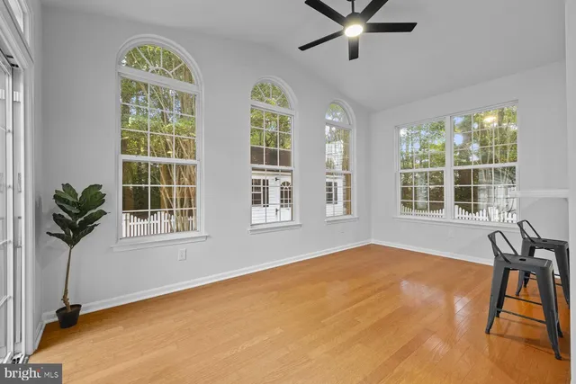 a view of a livingroom with a window and wooden floor