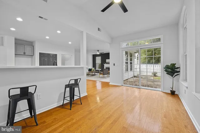 a view of a kitchen with dining table chairs and wooden floor