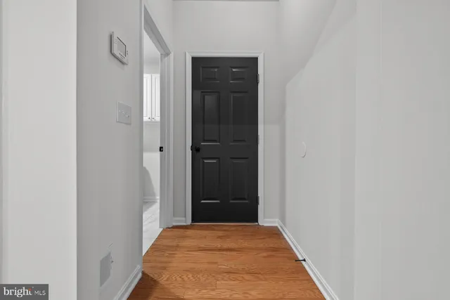 a view of hallway with closet and bathroom