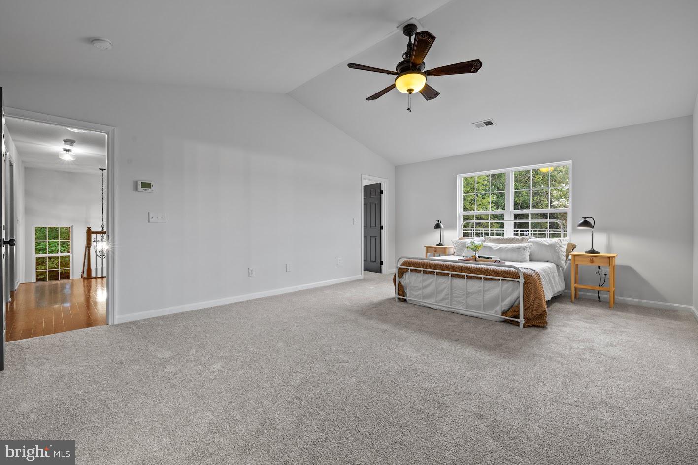 1111 Ruddy Duck Court Denton, MD 21629 - Photo 24 of 48 a bedroom with a bed and a chandelier