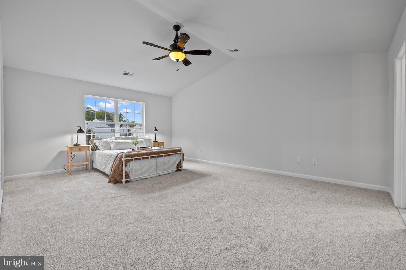 1111 Ruddy Duck Court Denton, MD 21629 - Photo 25 of 48 a bedroom with a bed and a chandelier fan
