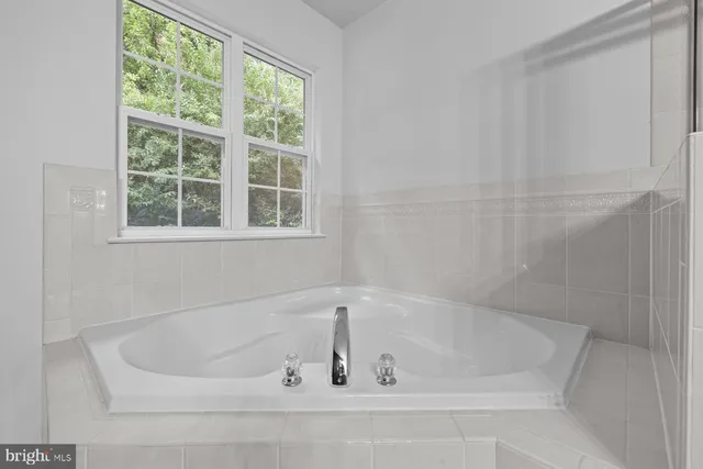 a white bath tub sitting next to a window