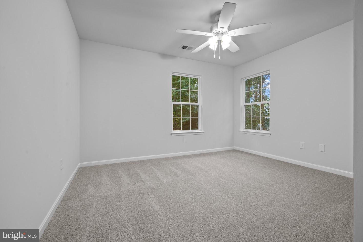 1111 Ruddy Duck Court Denton, MD 21629 - Photo 35 of 48 an empty room with windows and ceiling fan