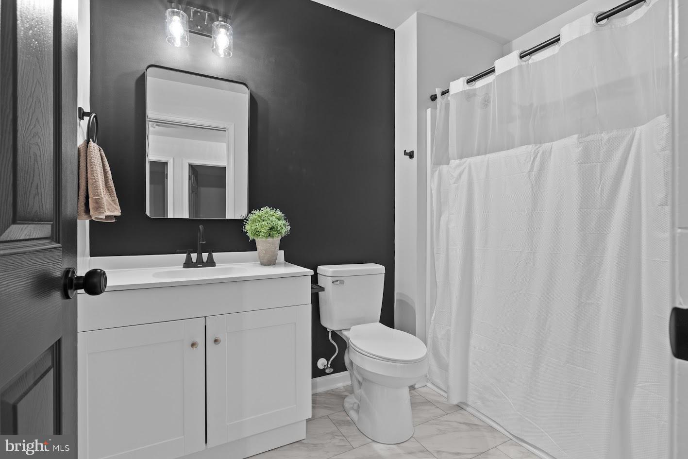 1111 Ruddy Duck Court Denton, MD 21629 - Photo 37 of 48 a bathroom with a sink a toilet and shower