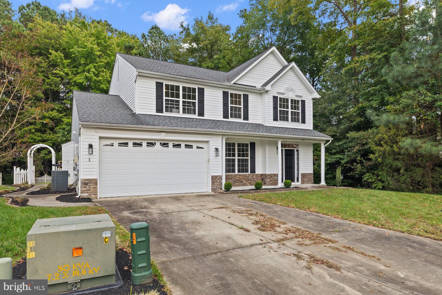 1111 Ruddy Duck Court Denton, MD 21629 - Photo 40 of 48 a front view of a house with a yard and garage