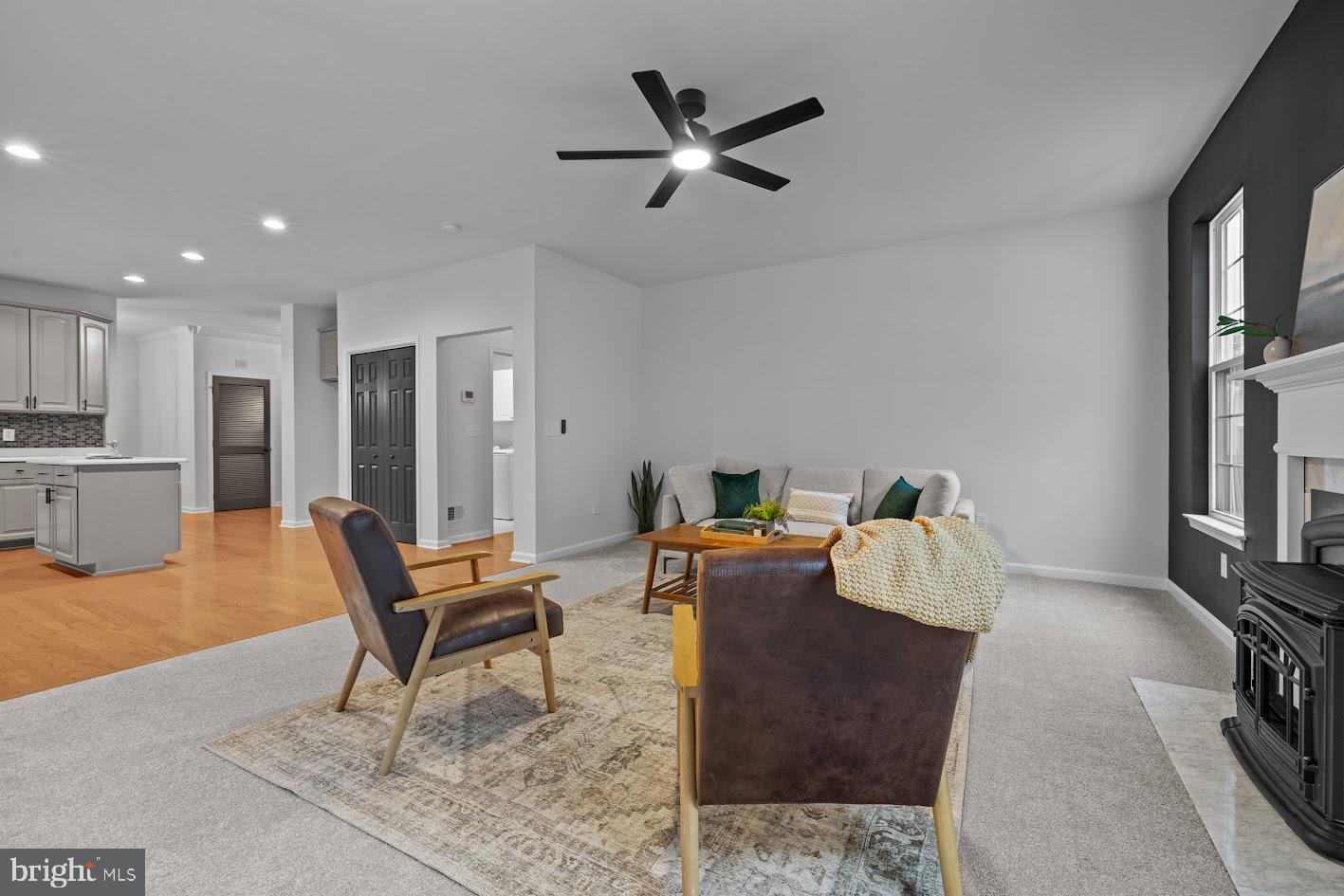 1111 Ruddy Duck Court Denton, MD 21629 - Photo 4 of 48 a living room with furniture a fireplace and a flat screen tv