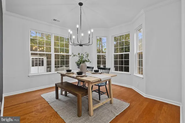 a workspace with furniture window and wooden floor