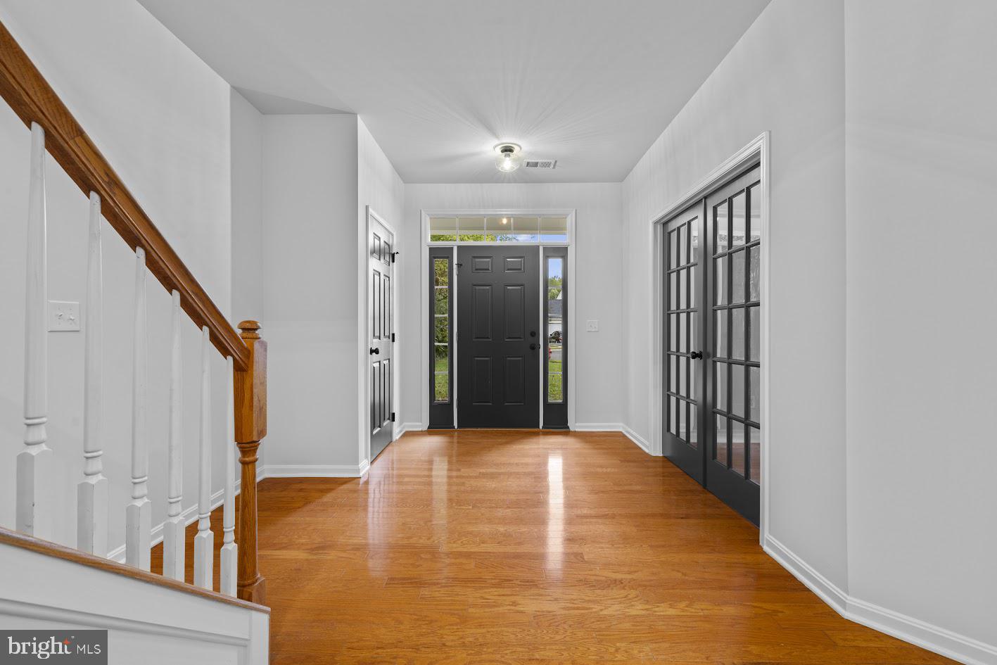1111 Ruddy Duck Court Denton, MD 21629 - Photo 9 of 48 a view of a hallway with wooden floor and staircase