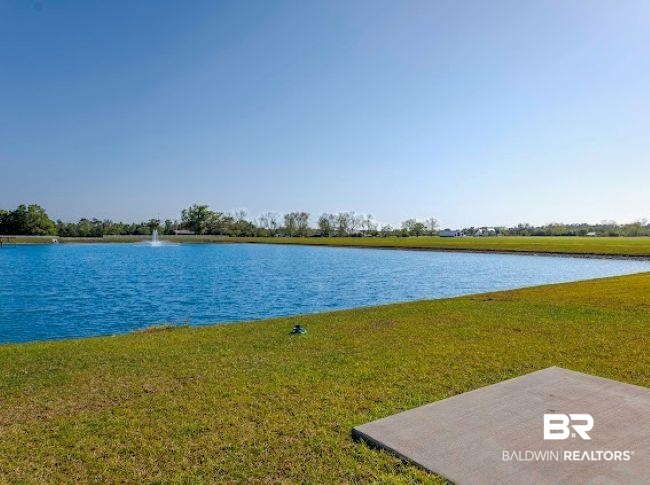 16810 Rocher Court Foley, AL 36535 - Photo 24 of 24 Expansive waterfront setting featuring a vibrant blue pond with a central fountain