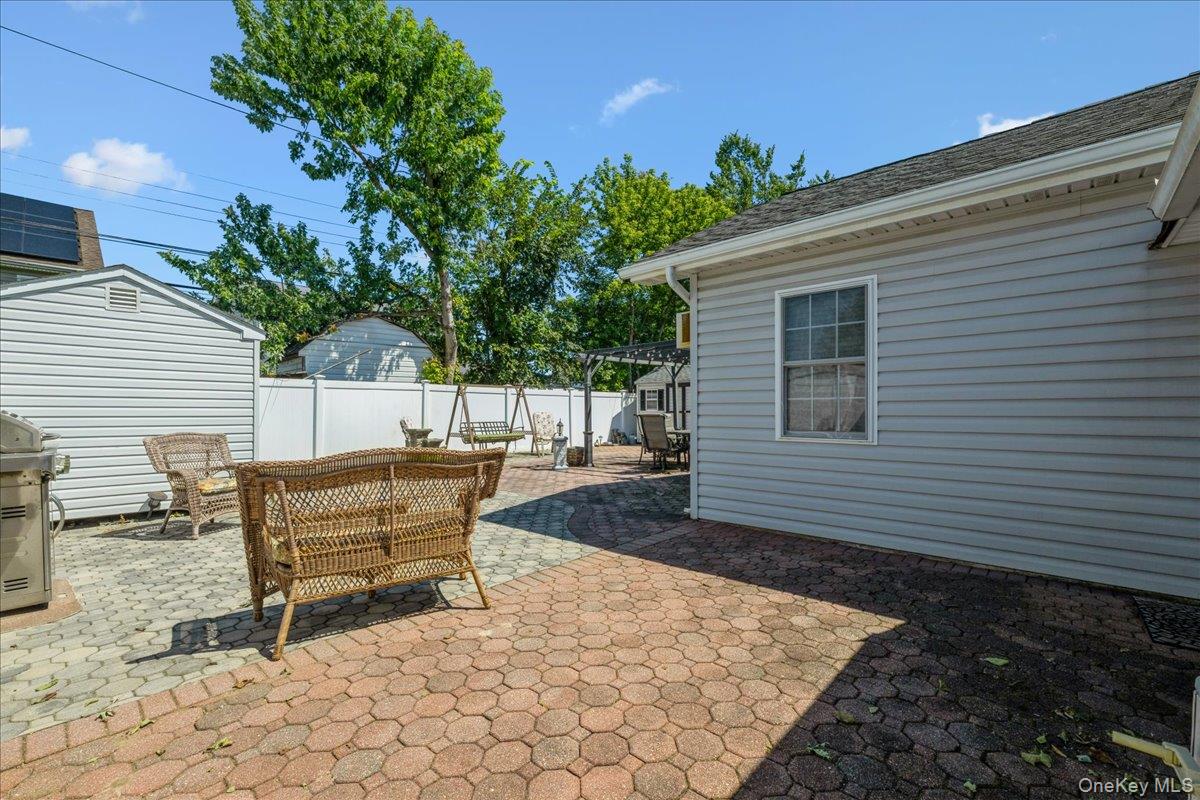 181 Springtime Lane North Levittown, NY 11756 - Photo 20 of 22 Fenced backyard with a patio area, grilling area, and an outbuilding