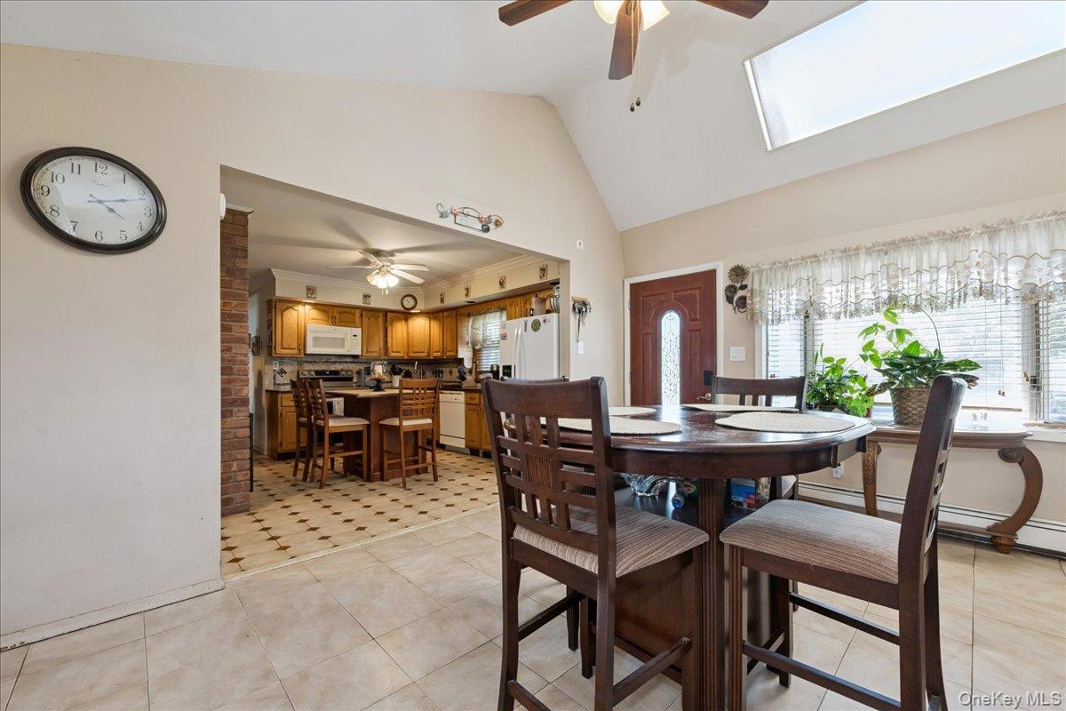 181 Springtime Lane North Levittown, NY 11756 - Photo 4 of 22 Dining room featuring ceiling fan, plenty of natural light, and high vaulted ceiling