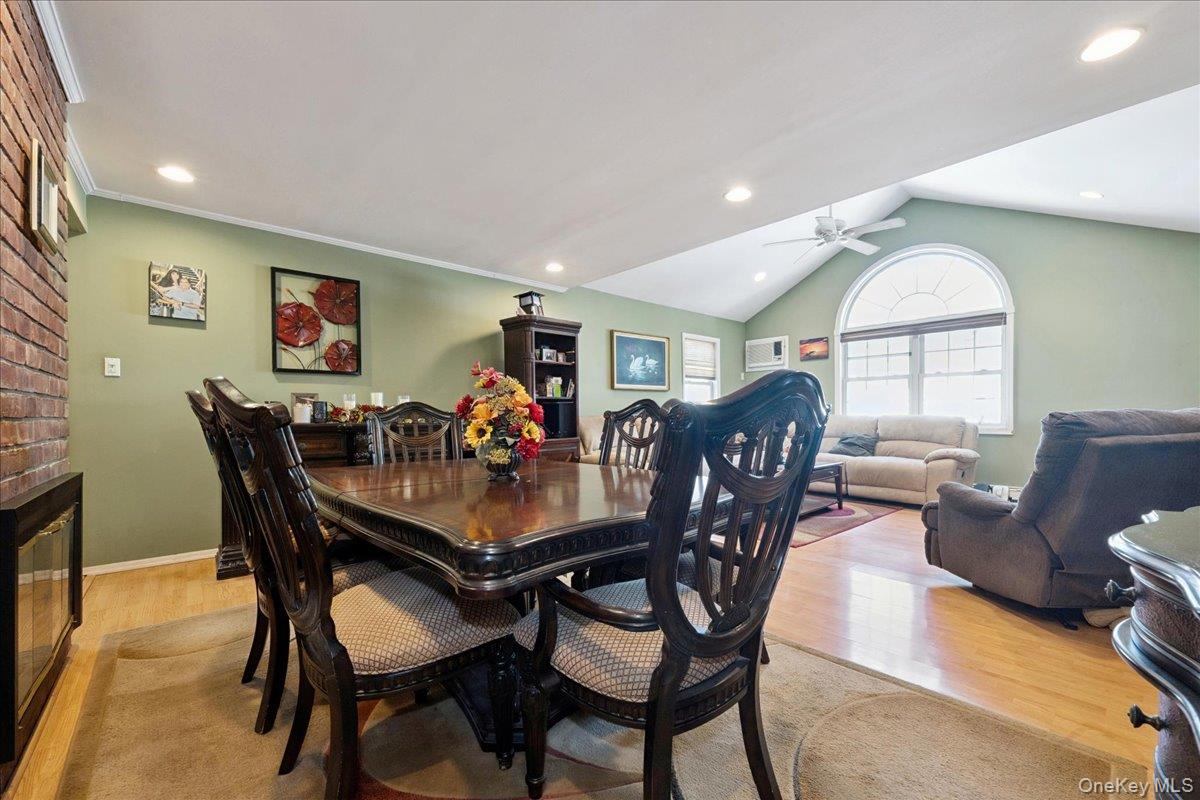 181 Springtime Lane North Levittown, NY 11756 - Photo 7 of 22 Dining space featuring vaulted ceiling, light wood-style flooring, recessed lighting, and a ceiling fan