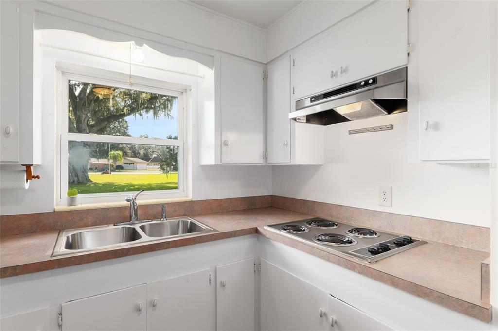 3430 Southwest 27th Street Ocala, FL 34474 - Photo 21 of 53 a kitchen with stainless steel appliances cabinets and a window