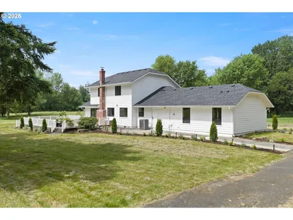a house view with a sitting space garden and patio