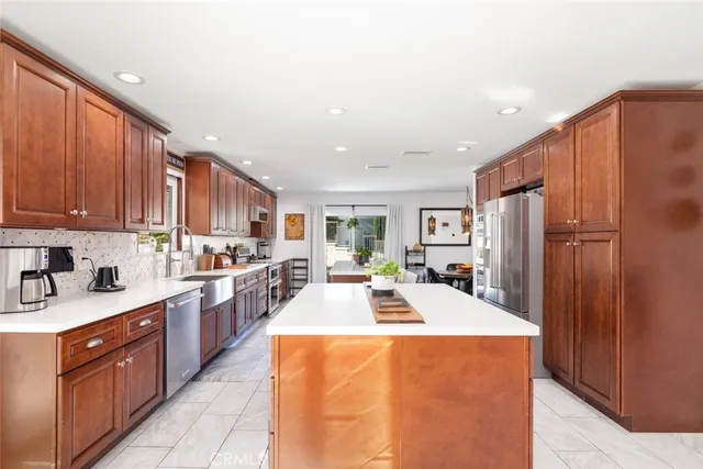 a kitchen with a stove a sink a dining table and chairs