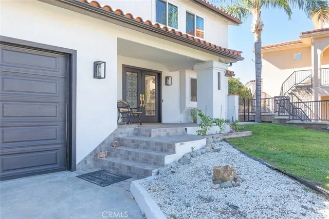 a view of a house with swimming pool and sitting area