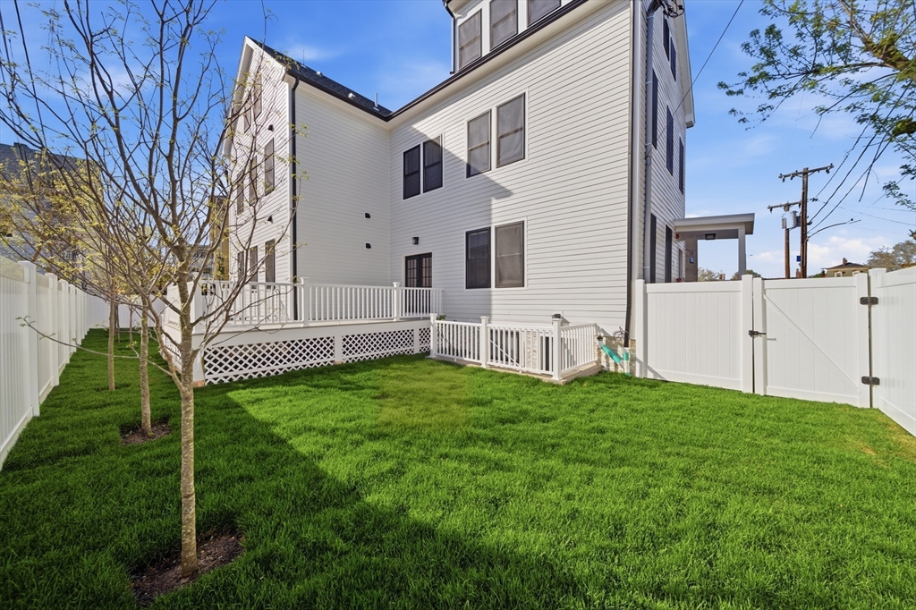 174 Walnut Street, Unit 3 Somerville, MA 02145 - Photo 37 of 38 a white house with a big yard and large trees