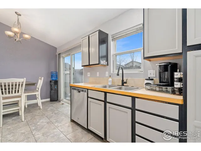 a kitchen with stainless steel appliances kitchen island granite countertop a stove a sink and a refrigerator with wooden floor