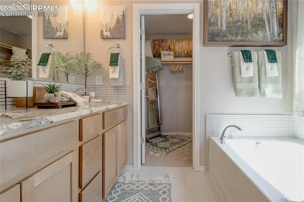 a bathroom with a tub sink and mirror