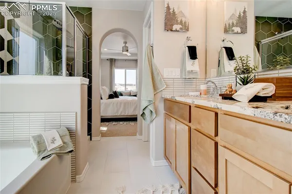 a en suite spacious bathroom with a granite countertop sink mirror and vanity