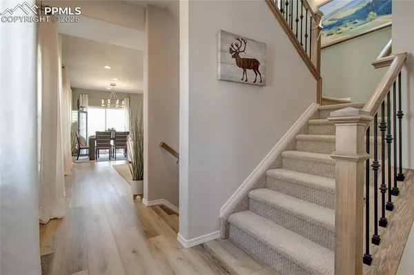a view of entryway and hall with wooden floor