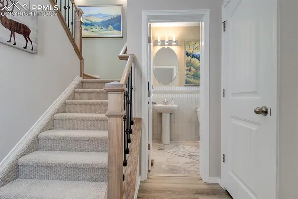 a view of a hallway with wooden floor and entryway