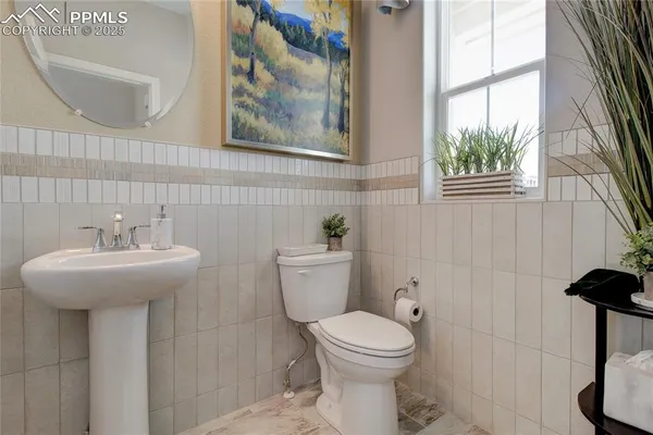 a bathroom with a sink a mirror and a toilet