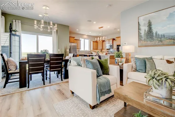 a living room with furniture and a chandelier