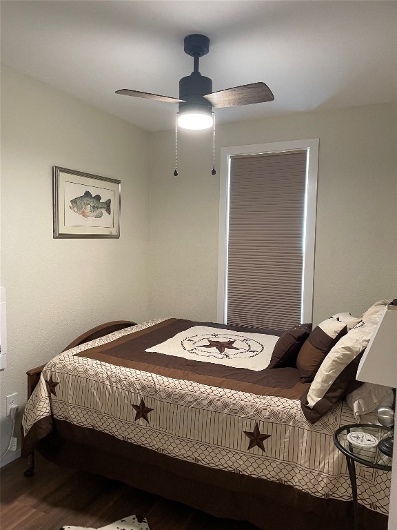 131 Alexander Drive, Unit 10 Tow, TX 78672 - Photo 7 of 11 a bedroom with a bed and a chandelier