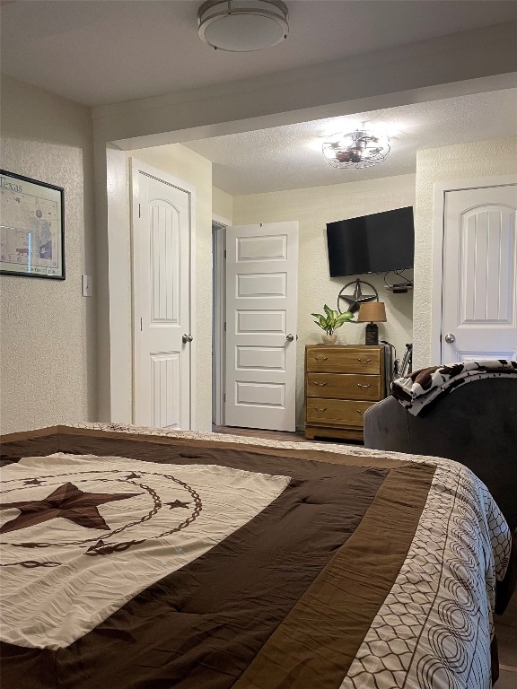 131 Alexander Drive, Unit 10 Tow, TX 78672 - Photo 9 of 11 a bedroom with a bed and a flat screen tv