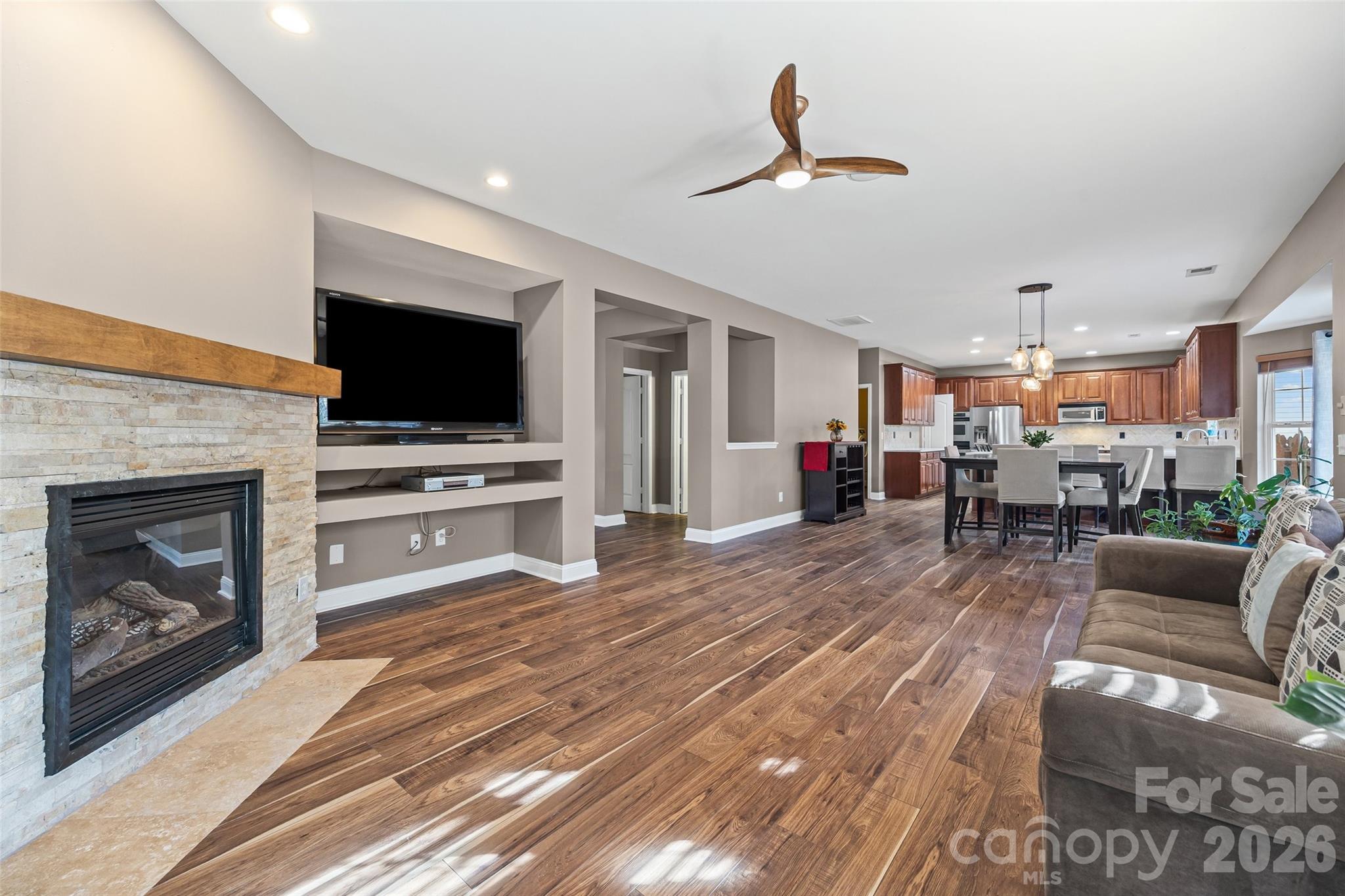 240 Loch Stone Street Fort Mill, SC 29715 - Photo 12 of 45 a living room with furniture a fireplace and a flat screen tv