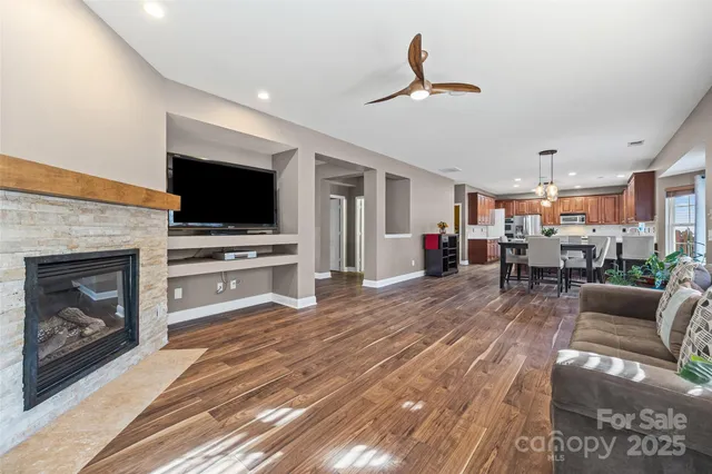 a living room with furniture a fireplace and a flat screen tv