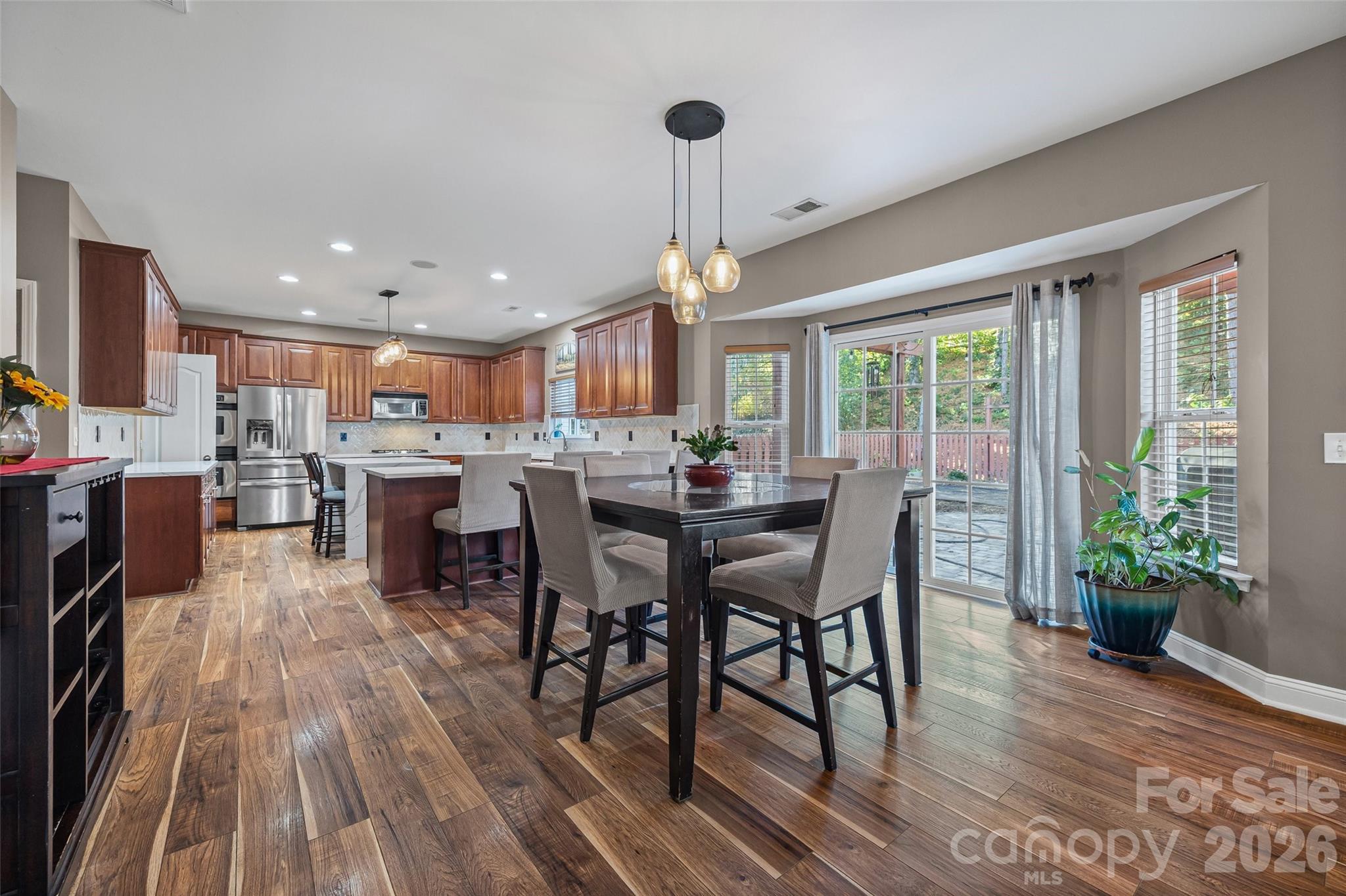240 Loch Stone Street Fort Mill, SC 29715 - Photo 13 of 45 a dining room with furniture and a floor to ceiling window