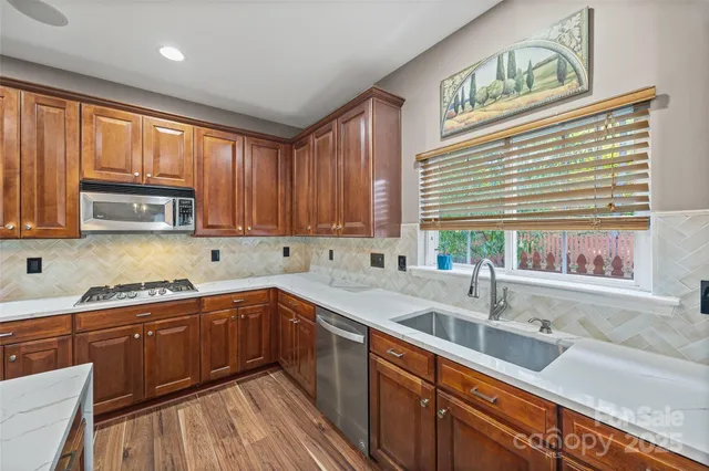 a kitchen with a sink cabinets and window